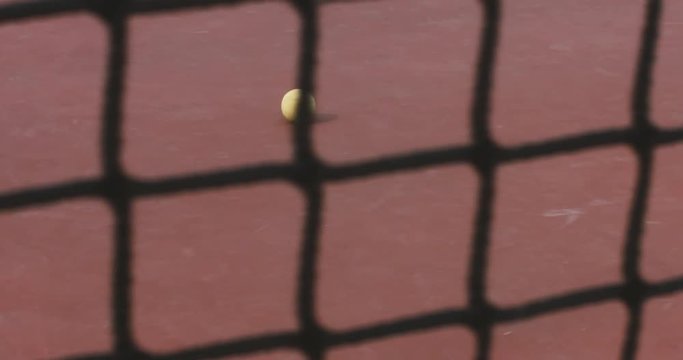 DOLLY CU shot of tennis ball rolling on a surface of an outdoor tennis hardcourt. 4K UHD