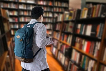 Happy  Student with backpack go to holding books library bookshelves