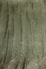 Gray shiny textured acrylic paint with glitter background