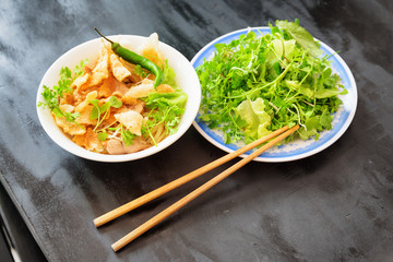 Bowl of Cao Lau in street cafe in Hoi An