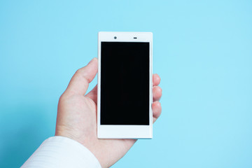 Using mobile phones in business scene..  スマートフォンを使う　水色背景