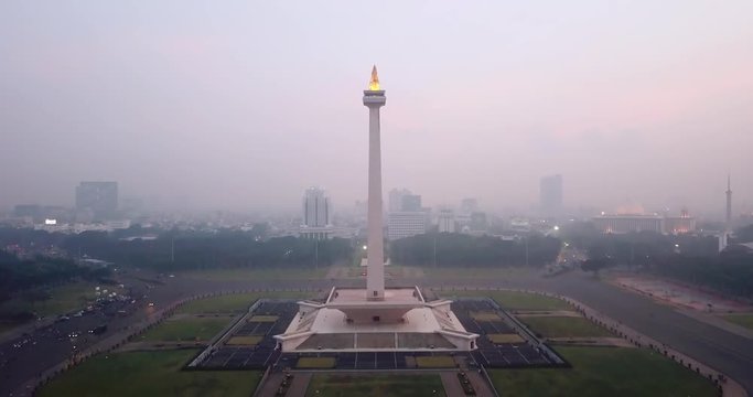 JAKARTA, Indonesia - May 30, 2018: Drone View Of National Monument Jakarta With Fog On Dusk Time In Merdeka Square. Shot In 4k Resolution From A Drone