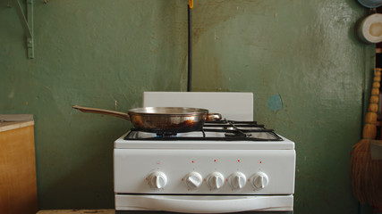 Steel pan on a gas stove in an old kitchen of a communal flat - 207859369