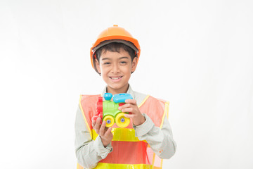 Little engineer boy take a small house block building in hand