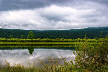 lake forest in cloudy weather in summer, before storm Siberia.