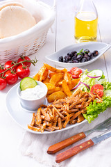 gyros plate it green salad ,olives and potato wedges