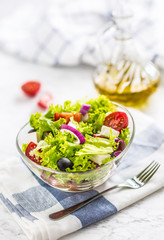 Spring vegetable salad with tomatoes onion cheese and olives.