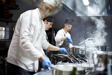 Group of chefs working in the kitchen