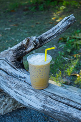 Iced coffee is placed with a log.