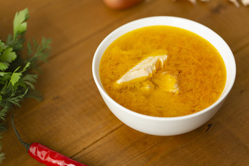 Fresh fish soup with ingredients and spices for cooking. Wooden background