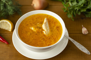 Fresh fish soup with ingredients and spices for cooking. Wooden background