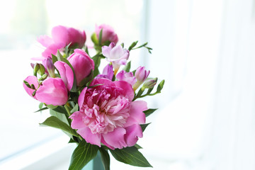 Fototapeta na wymiar Vase with beautiful peony flowers on windowsill indoors