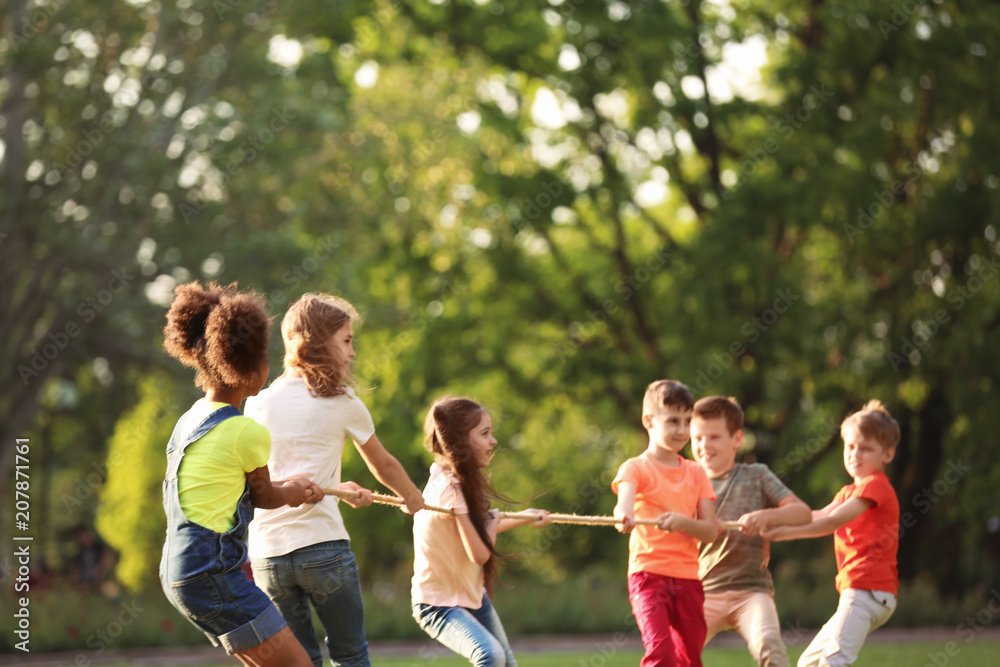 Sticker Cute little children playing with rope outdoors on sunny day