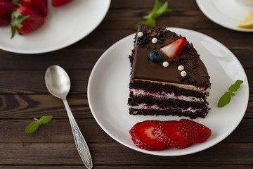 Delicious chocolate cake with strawberries on a plate