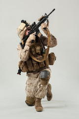 Soldier in camouflage holding rifle