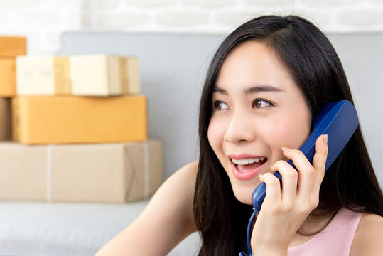 Woman freelance seller calling  customer on the phone to confirm orders