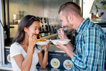 Couple eating pasta at food truck