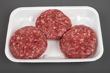 beef burgers in plastic package isolated on white background