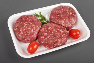 beef burgers in plastic package isolated on white background