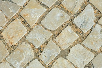 Square stone pavement cobbles, Algarve, Portugal.