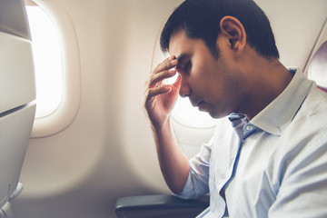 Male passenger having airsickness on the plane