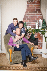 Obraz premium Family consists mother, grandfather, grandson in the room decorated for Christmas
