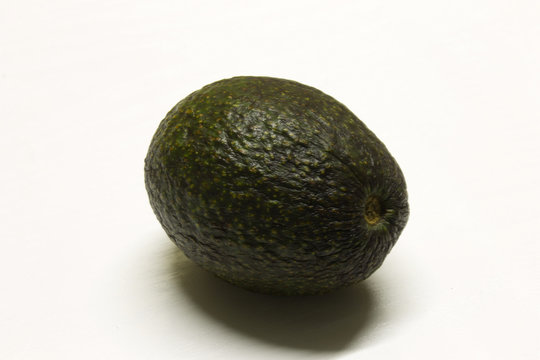Avocado isolated on a White textured background with a dark shadow
