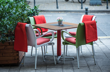 Empty dining table and chairs in a street cafe