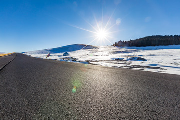   The frozen Sailimu lake with snow mountain background at Yili, Xinjiang of China