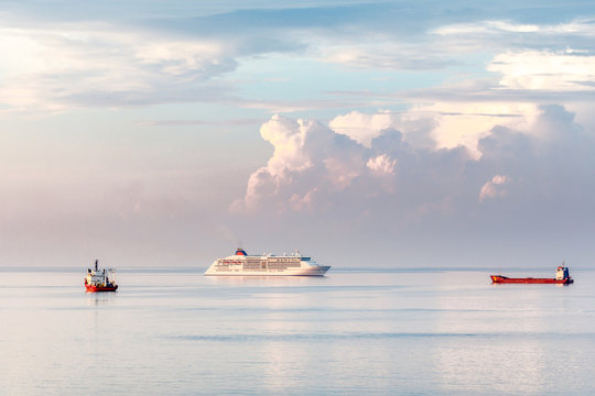 Cruise passenger liner and cargo vessels on the sea surface