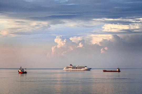 Cruise liner and cargo vessels on the sea surface