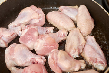 Chicken wings fried in pan with hot oil, homemade food