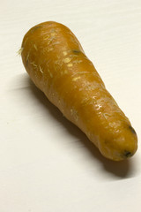 Carrot isolated on a White textured background with a dark shadow