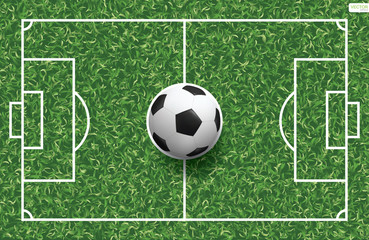 Fototapeta na wymiar Soccer football ball on green grass of soccer field background. Vector.