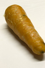 Carrot isolated on a White textured background with a dark shadow