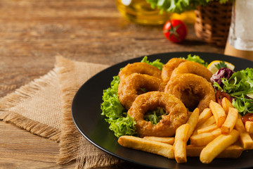 Roasted squid rings with fries.