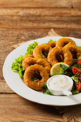 Roasted squid rings with salad.