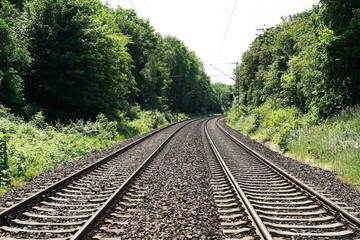 Obraz premium double-track railroad railway or train tracks in rural Germany, travel concept background with copy space