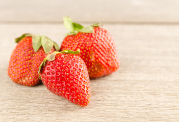 Fresh strawberries on old wooden background