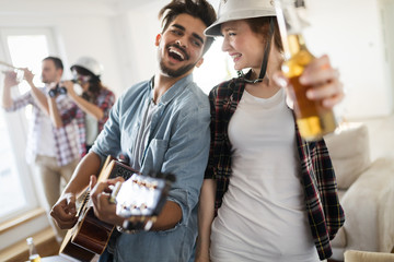 Group of happy young friends having fun and drinking beer