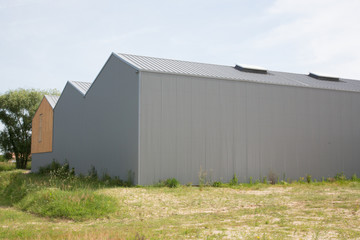 Fototapeta na wymiar Silver building exterior of distribution warehouse depot