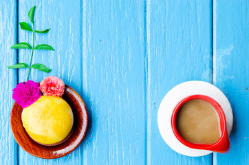 Good morning world. cup of coffee and yellow pie on blue background,top view ,empty space.