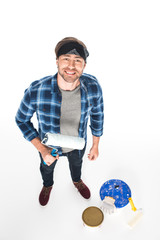 high angle view of man in headband standing with paint roller isolated on white background