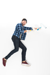 Naklejka premium side view of smiling man in protective gloves with paint rollers isolated on white background