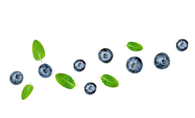 Fresh blueberries with leaves isolated on white background, top view. Berry ornament, flat lay.
