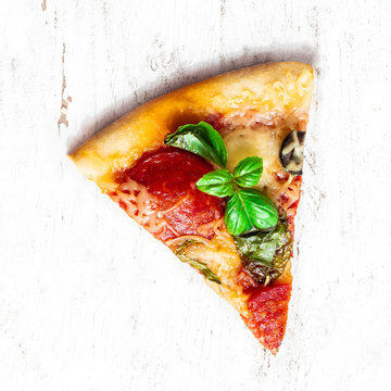 Slice of fresh Italian classic original Pepperoni Pizza on  white wooden rustic table. Cheese Pizza on white background, top view. Copy space.