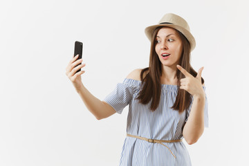 Young beautiful woman dressed blue dress, hat doing selfie shot on mobile phone or video call isolated on white background. People, sincere emotions, lifestyle concept. Advertising area. Copy space.