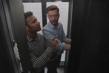 Team discussion. Top view of experienced IT technicians talking and fixing problem with server