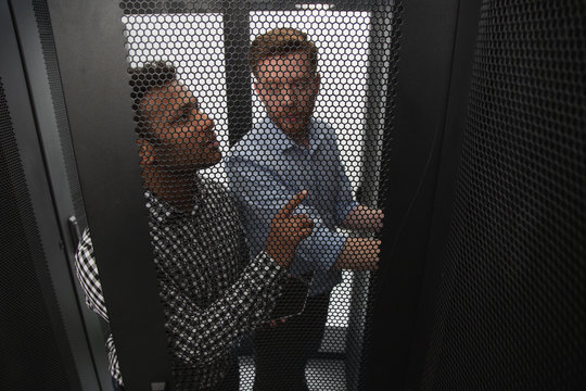 Team discussion. Top view of experienced IT technicians talking and fixing problem with server