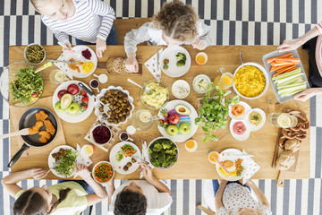 Top view on children eating healthy food during friend's birthday party